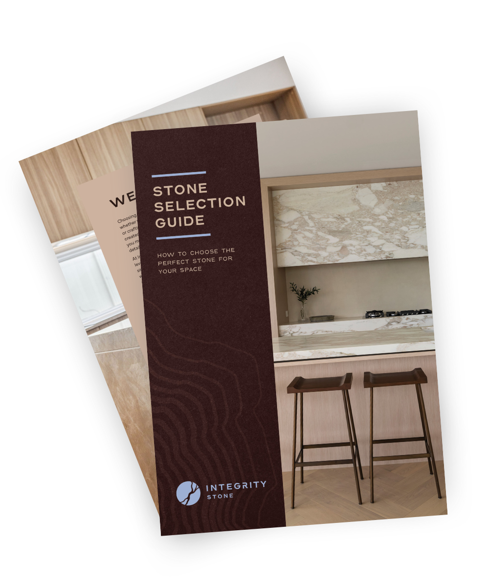 Stacked brochures showing "Stone Selection Guide," Integrity Stone logo, and luxury worktops. Gold Coast location featured.